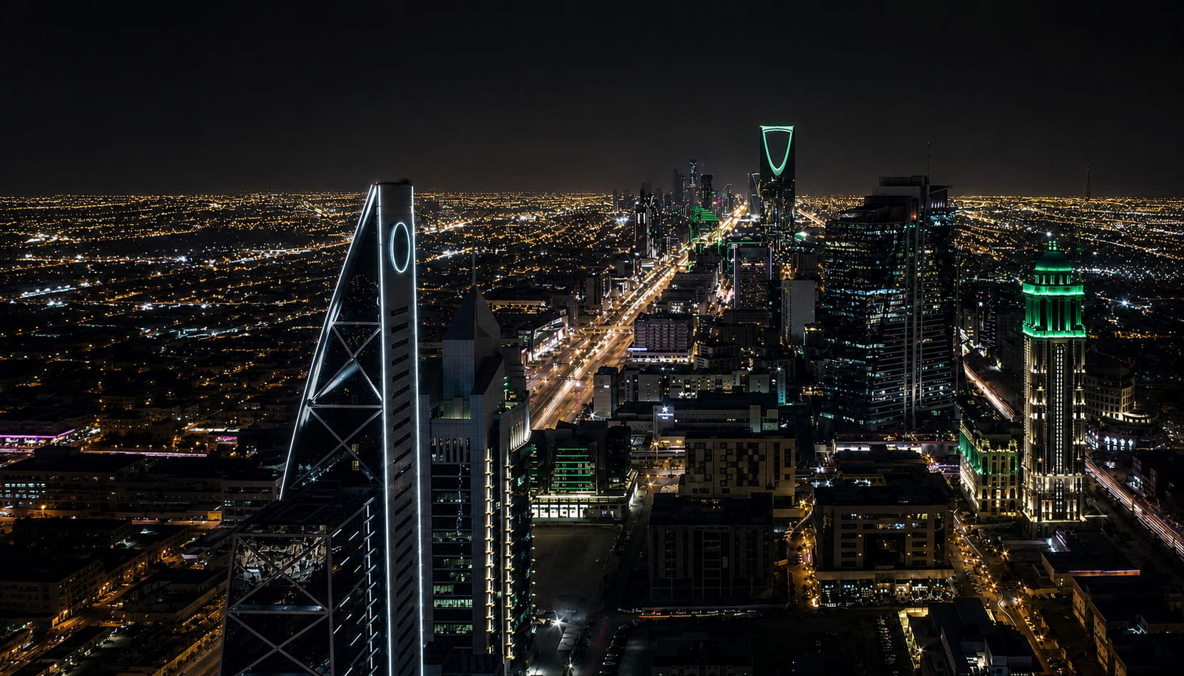 Riyadh skyline at dusk with Kingdom Centre Tower illuminated in green